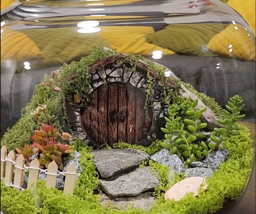 A terrarium themed as a Hobbit door from the lord of the rings movies.